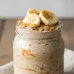 Creamy blended overnight oats with peanut butter, banana, and cinnamon topping.