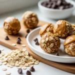 Peanut butter oatmeal balls with chocolate chips on a rustic wooden board