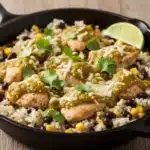 Salsa verde chicken and rice skillet with beans, corn, and cheese.