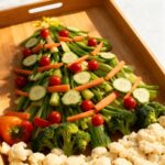Christmas tree veggie tray with broccoli tomatoes and bell peppers