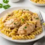 Creamy garlic parmesan chicken with cheesy twisted pasta recipe.