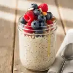 Creamy overnight oats with fresh berries, chia seeds, and almond slices.