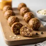Healthy protein balls with oats and chocolate chips on a rustic board