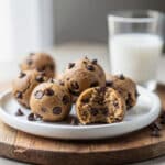 No-bake protein cookie dough balls with chocolate chips and milk.
