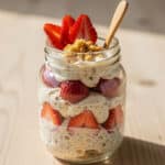 Creamy strawberry shortcake overnight oats in a clear glass jar.