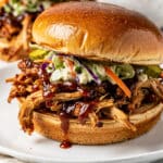 Juicy BBQ pulled chicken piled high on a toasted buttered brioche bun
