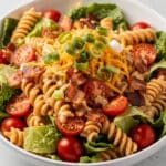 Creamy BLT pasta salad with bacon, lettuce, and tomatoes on rotini.