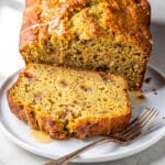 Moist buttermilk banana bread slice with creamy crumb and walnuts, close up food photo.