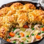 Creamy chicken pot pie casserole with vegetables and golden flaky biscuits.