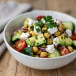 Creamy chickpea feta avocado salad with fresh vegetables and lemon vinaigrette.