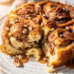 Homemade cinnamon roll breakfast casserole with gooey icing drizzle close up