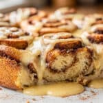 Cinnamon roll French toast bake with streusel topping and icing drizzle.