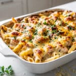 Creamy chicken Alfredo bake with golden cheese topping in close up food photo