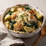 Creamy chicken orzo dinner recipe with spinach and artichoke hearts.