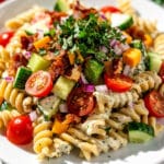 Creamy ranch pasta salad with rotini, bacon, and cheddar in a bowl.