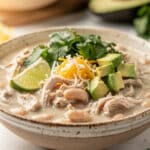Creamy white chicken chili recipe in a rustic bowl with corn and beans