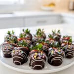 Easter chocolate covered strawberries with glossy dark chocolate and sprinkles.