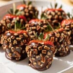 Easter chocolate covered strawberries with toasted pecan coating on white platter
