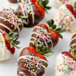 Easter chocolate covered strawberries with colorful sprinkles on a white plate