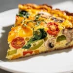 Colorful garden veggie frittata recipe with creamy eggs and crispy vegetables.
