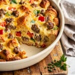 Savory breakfast casserole with sausage, peppers, cheese, and golden crust.