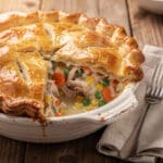 Golden flaky puff pastry crust on a creamy turkey pot pie recipe.