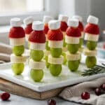 Festive Grinch fruit sticks with grapes strawberries bananas and marshmallows