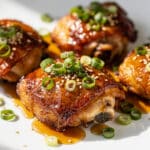 Crispy honey garlic chicken thighs with rice and steamed broccoli side.