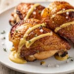 Honey mustard baked chicken thighs with crispy skin and glossy glaze.