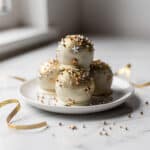Elegant New Years Eve cake ball drops with festive gold and silver sprinkles.
