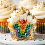 Colorful rainbow swirl cupcakes with vanilla frosting and rainbow sprinkles.