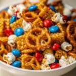 Colorful red and blue fish snack mix recipe with popcorn and pretzels.