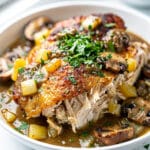 Slow cooker chicken and gravy recipe served over creamy mashed potatoes.
