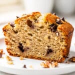 Moist sour cream banana bread slice with glossy crust and creamy crumb.