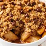 Warm apple crisp with oat topping and melted dark chocolate chips.