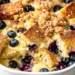 Golden brown blueberry French toast bake with cinnamon streusel and maple syrup.