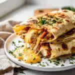 Golden crispy tortilla wrap filled with cheesy garlic butter chicken recipe.