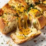 Close up of homemade cheesy pull apart garlic bread with melted cheese