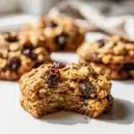 Chewy oatmeal raisin cookies with plump raisins and a glass of milk.