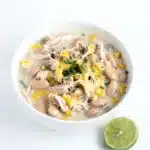 Creamy white chicken chili recipe in a rustic bowl with beans