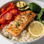 Garlic herb salmon rice bowl with vibrant sauteed vegetables and fluffy white rice