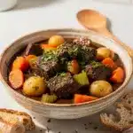 Hearty Guinness beef stew with tender chunks in glossy gravy close up