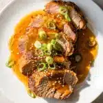 Slow cooker honey garlic pork tenderloin with sticky glaze and sesame seeds