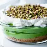 Layered no bake pistachio pudding dessert with creamy filling and crunchy crust