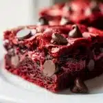 Decadent red velvet brownies with creamy frosting in close up food photo