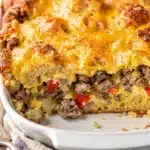 Sausage egg and cheese breakfast casserole slice with melted cheese pull