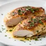 Golden brown seared chicken breast with lemon herb pan sauce recipe.