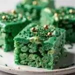 Vibrant green Shamrock Rice Krispie Treats with glossy marshmallow coating and crispy cereal.