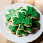 Vibrant green shamrock sugar cookies with white icing on a rustic table.