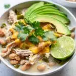 Creamy slow cooker white chicken chili with beans and fresh avocado garnish
